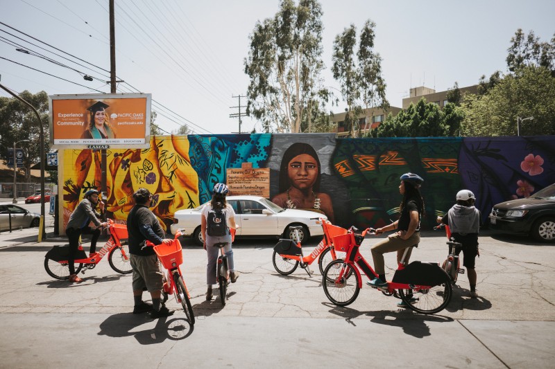Electro Bici riders stop to admire the neighborhood art