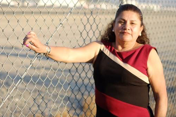 Person standing next to fence