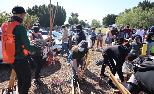 Community members participate in an Earth Day Clean Up