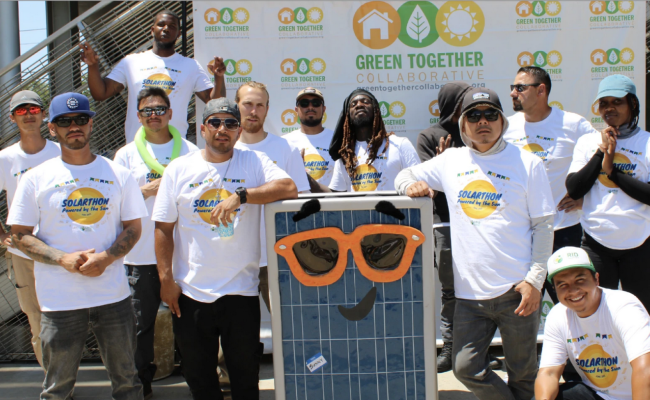 Workers with solar installer GRID Alternatives pose with Pacoima Beautiful and other community members at the First Annual Solarthon at Pacoima City Hall in June 2022. 