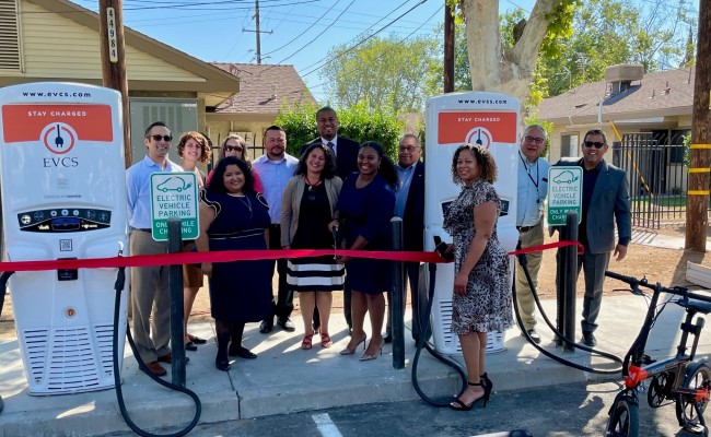 Keshia Thomas (front center) celebrates new Transformative Climate Communities-funded electric vehicle charging infrastructure installed at an affordable housing site in southwest Fresno. Learn more about Keshia later in this story (third bullet). Photo credit: Fresno Housing