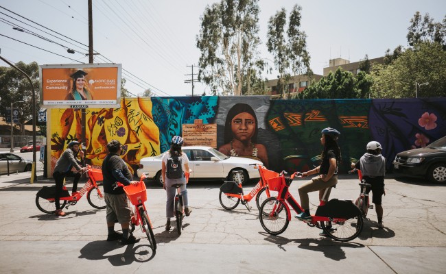 Electro Bici riders stop to admire the neighborhood art