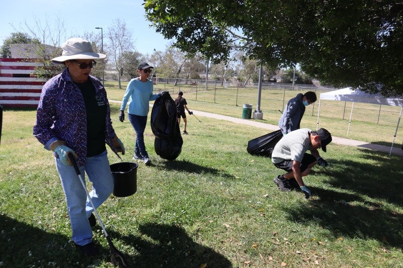 Community members participate in an Earth Day Clean Up