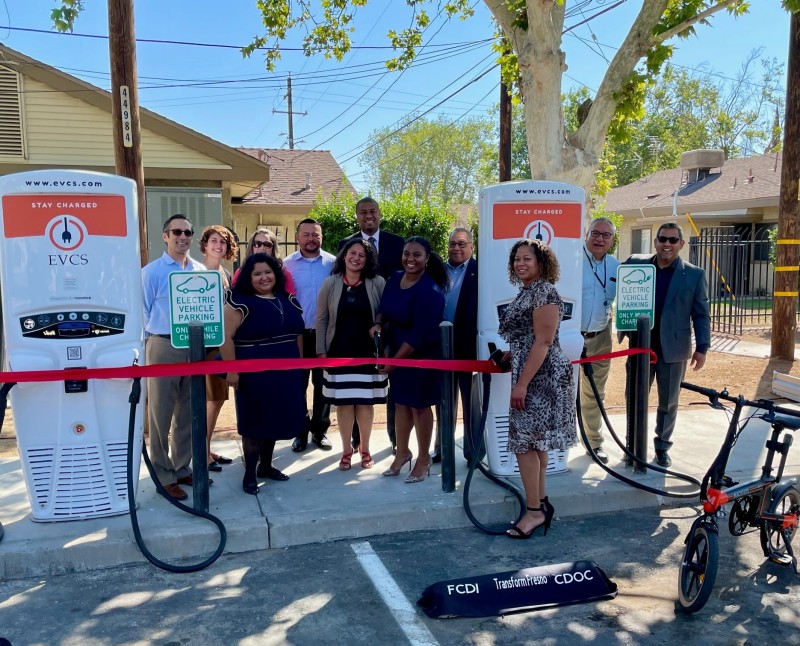 Keshia Thomas (front center) celebrates new Transformative Climate Communities-funded electric vehicle charging infrastructure installed at an affordable housing site in southwest Fresno. Learn more about Keshia later in this story (third bullet). Photo credit: Fresno Housing